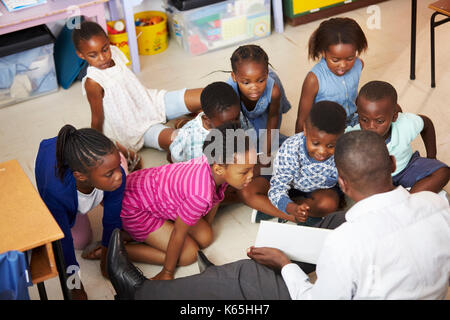 Lecture d'un livre pour enfants de l'enseignant dans une école élémentaire leçon Banque D'Images