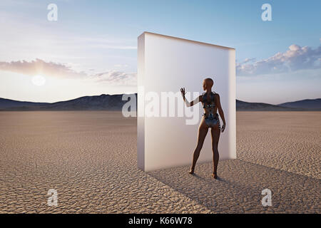 Futuristic woman touching glass wall in desert Banque D'Images