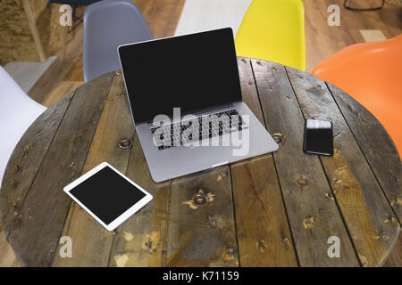 High angle view of laptop with digital tablet and mobile phone on wooden table in cafe Banque D'Images
