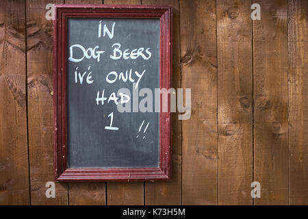 Signe humoristique sur un mur ou une clôture en bois dans un pub, dans le Yorkshire, Royaume-Uni. Banque D'Images