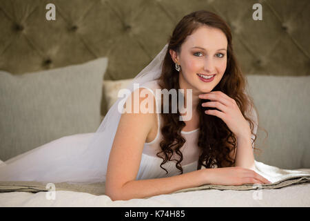 Portrait de belle mariée robe de mariage en lying on bed at home Banque D'Images