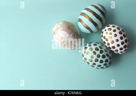 Oeufs de Pâques décorés avec bloc-notes florales et une tasse de thé à la menthe sur fond turquoise bleu sarcelle aqua with copy space Banque D'Images