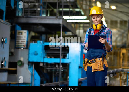 Travailleur d'usine attrayant avec presse-papiers Banque D'Images