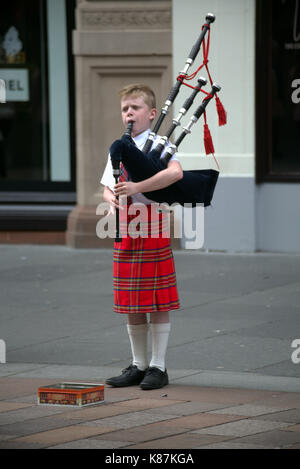 Jeune garçon en kilt en tartan Royal stewart piper musicien musicien ambulant sur Buchanan Street Glasgow Ecosse le style mile biscuit tin Banque D'Images