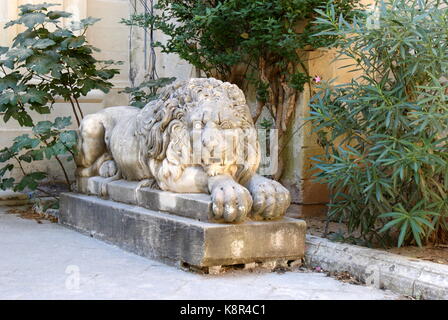 Lion en pierre dans la cour du palais des Grands Maîtres, La Valette, Malte Banque D'Images