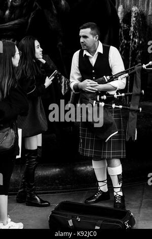 Les femmes qui discutent avec un artiste de rue, Piccadilly Circus, Londres, UK Banque D'Images