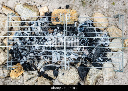 Barbecue Barbecue improvisé fait maison sur plage de sable en vacances. faire un feu, charbon, briquettes barbecue dans le sable avec des roches et des pierres sur le Banque D'Images