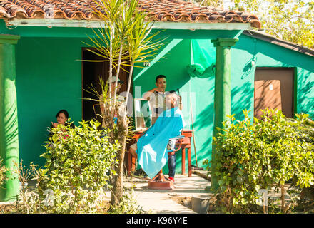 Salon de coiffure la coupe de cheveux d'un homme sur le porche, à l'extérieur de coiffure, Viñales, Pinar del rio, Cuba, Caraïbes Banque D'Images