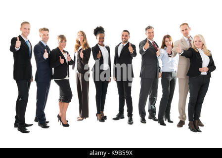 Portrait de l'équipe commerciale showing Thumbs up against white background Banque D'Images