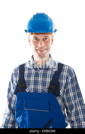 Portrait of mid adult construction worker standing against white background Banque D'Images