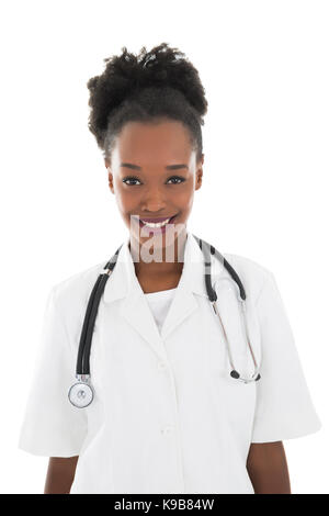 Portrait of happy female doctor standing against white background Banque D'Images
