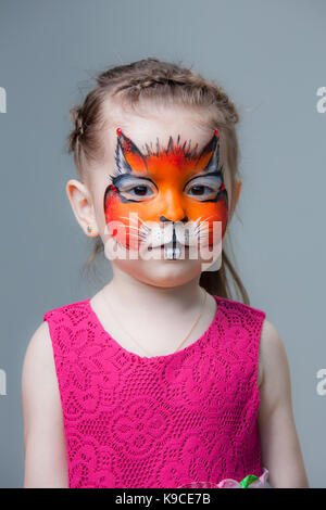 Belle petite fille avec un fox peint sur son visage. La peinture du visage Banque D'Images