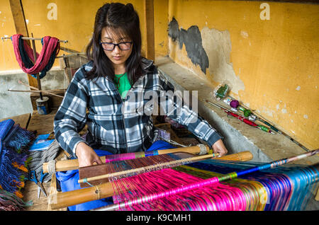 Thimphu, Bhoutan - le 9 avril 2016 : un tissage femmes bhoutanaises chiffon avec machine traditionnelle au village de Thimphu, Bhoutan - tissage tissu bhoutanais mach Banque D'Images