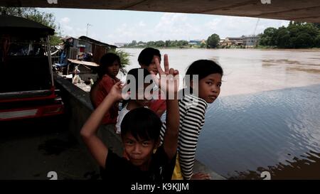 Phnom Penh Cambodge Monivong Bridge Bassac River Slum Area enfants jouant et agitant à la caméra Banque D'Images