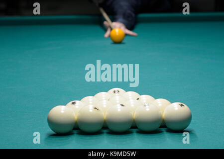 Un joueur du bras avec un repère sur une table de billard prêt à temps une balle Banque D'Images