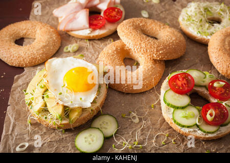 Choix de sandwichs sur bagels : œuf, avocat, tomate, jambon, fromage, les germes de luzerne Banque D'Images