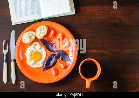 Les œufs et les tomates mozzarella au basilic sur plaque orange Banque D'Images