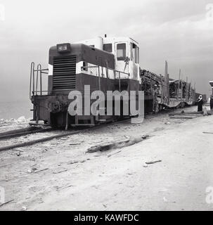 Historique années 1950, photo prise en Arabie Saoudite par J Toutes les espèces d'une grande locomotive tirant des wagons de trains de marchandises chargées dans le désert à cette époque de l'exploration pétrolière dans le pays. Banque D'Images