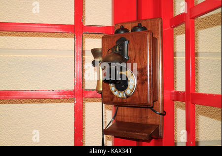 En bois de style vintage téléphone public dans la cabine téléphonique rouge Banque D'Images