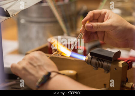 Cesky Krumlov, République tchèque - 17 août 2017 : artisan fonctionne un objet de verre avec une flamme dans le centre-ville historique Banque D'Images