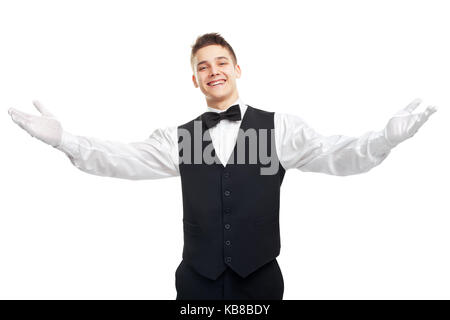 Portrait of young happy smiling waiter ouvre ses bras en signe de bienvenue isolé sur fond blanc Banque D'Images