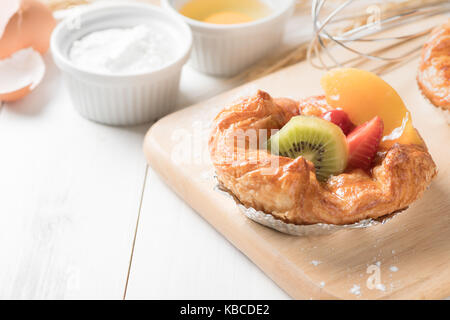 Pain danois avec orange kiwi et fraises sur fond de bois blanc, de l'alimentation boulangerie Banque D'Images