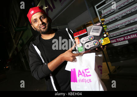 Un homme photographié avec sa nouvelle console de jeux SNES mini d'attente et qu'il a acheté à minuit le jour de la diffusion dans le magasin de jeux à Bognor Regis. Banque D'Images