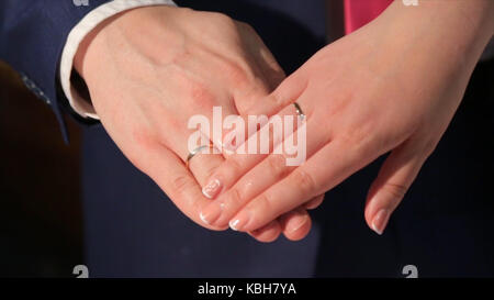 Couple de jeunes mariés ses mains avec de mariage. mariée et le marié avec les anneaux de mariage. les mains et les joints toriques sur le bouquet de mariage. mains de l'époux et l'épouse. vacances. famille mariage, mariée, marié et leurs enfants marcher dans le parc automne à jour de mariage. épouse et mari répète jour de mariage photo shoot, mais avec l'amour des enfants. Banque D'Images