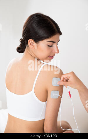 Close-up of young woman getting thérapie électrodes en main Banque D'Images