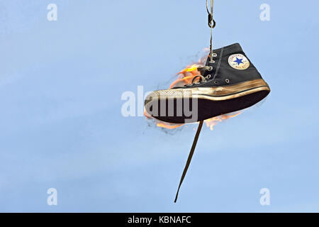 Burning converse against a blue sky Banque D'Images