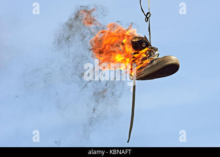 Burning converse against a blue sky Banque D'Images