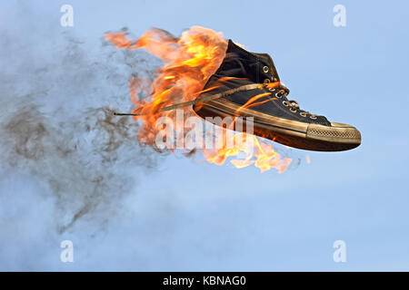 Burning converse against a blue sky Banque D'Images