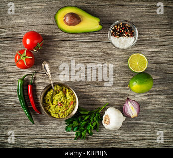 Avocado guacamole avec des ingrédients frais sur table en bois Banque D'Images