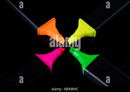 Surligneur de bureau sur un fond noir. office de tirer mazak gisent sur un comptoir noir. fond noir. Banque D'Images