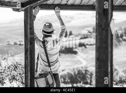 Découvrir une vue magique de la toscane. vu de dos femme randonneur dans hat en toscane à la recherche dans la distance et profiter de paysage en Banque D'Images