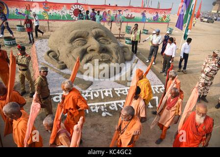 Allahabad, Uttar Pradesh, Inde. 2 octobre 2017. Sadhus passe près d'une sculpture de sable du Mahatma gandhi faite par les étudiants de l'Université Centrale Allahabad à l'occasion de l'anniversaire de naissance du Mahatma Gandhi à Allahabad. Credit: Prabhat Kumar Verma/ZUMA Wire/Alamy Live News Banque D'Images