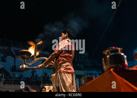 Varanasi, Inde - le 13 mars 2016 : horizontale photo de l'homme indien hindou non identifiés en prière avec le porte-bougie en mouvement religieux à ganga aarti Banque D'Images