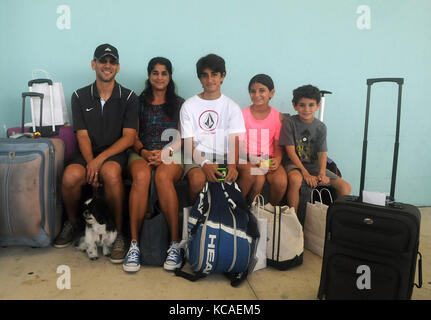 Fort Lauderdale, Floride, USA. 06Th oct, 2017. La famille Maldonado, victimes de l'ouragan maria, attendre pour le transport en arrivant à Port Everglades à Fort Lauderdale, Floride le 3 octobre 2017 après avoir été évacués de puerto rico à bord du navire de croisière Royal Caribbean Adventure of the seas. la famille prévoit de rester avec sa famille dans le new jersey jusqu'au rétablissement de leur maison de san juan. Le navire a quitté San Juan, Puerto Rico le 28 septembre avant la prise d'évacués et de la livraison des fournitures de secours à st. croix et st. thomas. Les quelque 3 800 passagers Banque D'Images