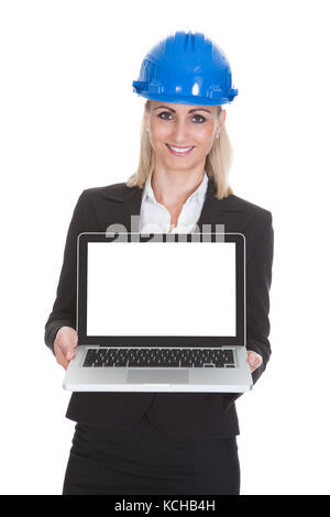 Portrait of happy female architect holding laptop over white background Banque D'Images