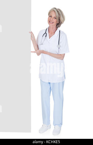 Female Doctor Holding Placard sur fond blanc Banque D'Images