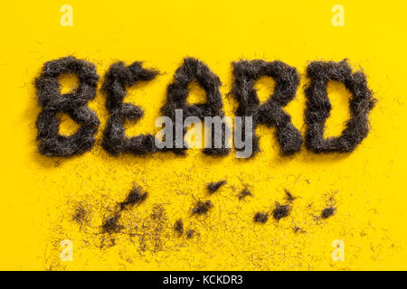 Beard signe fait en angle barbe sur un fond jaune lumineux Banque D'Images