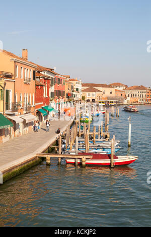 Afficher le long de la Riva Longa, Murano, Venise, Ialy au coucher du soleil avec des bâtiments colorés et bateaux amarrés, peu de touristes en passant devant les boutiques Banque D'Images