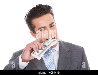 Portrait of young woman Biting Barre d'or sur fond blanc Banque D'Images