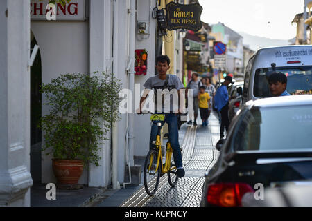 Phuket, Thaïlande. 5 octobre 2017. Un homme monte un vélo de partage ofo dans une zone commerciale de Phuket, Thaïlande, Oct. 5, 2017. La société chinoise de partage de vélos sans quai ofo a fourni plus de 1 000 vélos dans les endroits clés de Phuket fin septembre et a offert un essai gratuit d'un mois sans frais de dépôt. Maintenant, le service de partage de vélos a profité aux résidents locaux et aux touristes. Les frais de service réguliers d'OFO seront facturés à 5 Baht par 30 minutes d'utilisation, avec des frais de dépôt de 99 Baht. Crédit : Li Mangmang/Xinhua/Alamy Live News Banque D'Images