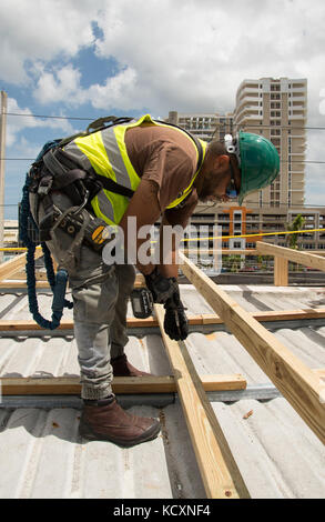 Un entrepreneur pour les Corps des ingénieurs à Puerto Rico travaille sur la première installation d'un premier pavillon bleu sur la Multy installations médicales à San Juan. Avoir le toit sera protégé à l'hôpital d'ouvrir d'autres lits de patients/chambres qui étaient auparavant inaccessibles à cause de la toiture endommagée. Banque D'Images