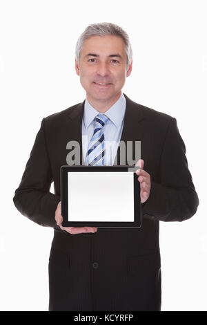 Mature businessman showing digital tablet over white background Banque D'Images