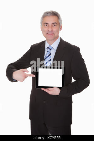 Mature businessman showing digital tablet over white background Banque D'Images