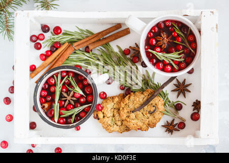 Décoration de Noël : vin chaud hiver chaud avec des canneberges et des épices dans une boîte en bois. Le béton arrière-plan, Vue de dessus. Banque D'Images