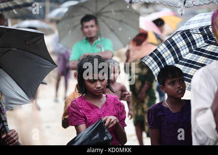 Teknaff, au Bangladesh. 8 oct, 2017. peuple Rohingya attend pour l'aide alimentaire au cours de la pluie à l'palongngkhali teknaff au camp de fortune, le Bangladesh le 08 octobre, 2017.Le Bangladesh a déclaré que ce serait l'un des plus gros de la came de réfugiés pour accueillir tous les 800 000 Rohingyas plus Musulmans qui ont demandé l'asile de la violence au Myanmar. crédit : zakir Hossain Chowdhury/zuma/Alamy fil live news Banque D'Images