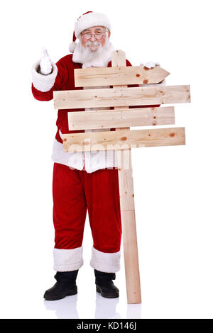 Happy santa claus holding panneau en bois et showing thumb up, isolé sur fond blanc Banque D'Images